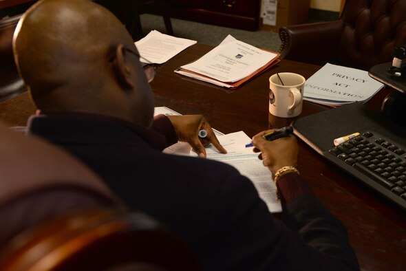 Department of the Air Force Kevin Alexander, the 354th Force Support Squadron chief of military personnel section (MPS), highlights parts of a document in his office Jan. 26, 2017, at Eielson Air Force Base, Alaska. As chief of the MPS, Alexander uses his time to instruct and mentor Airmen to help them improve. (U.S. Air Force photo by Airman Eric M. Fisher)