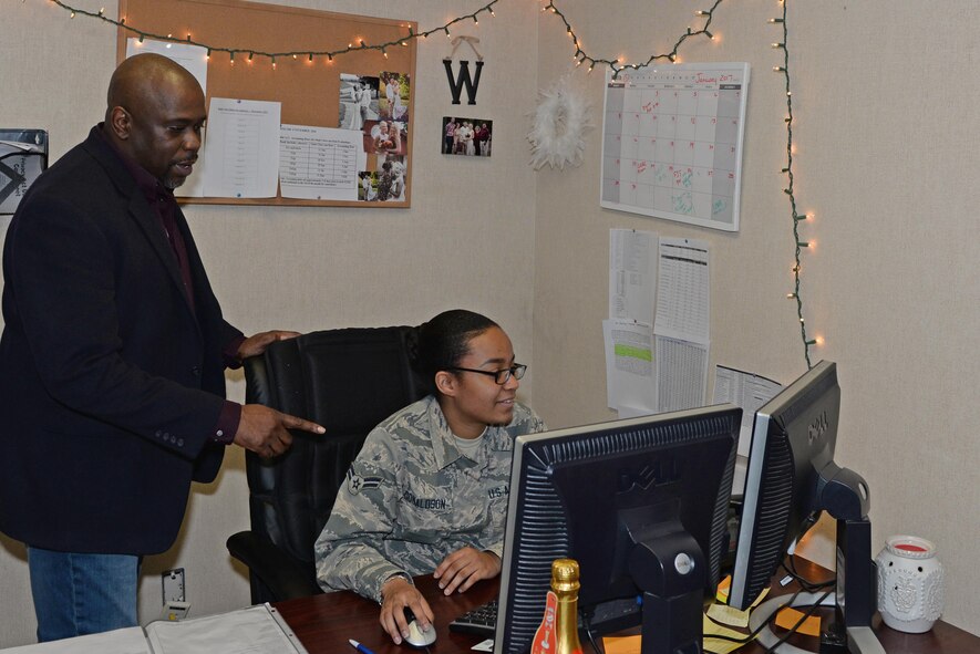 Department of the Air Force Kevin Alexander, the 354th Force Support Squadron chief of military personnel section (MPS), speaks with Airman 1st Class Anari Donaldson, a 354th FSS customer support journeyman, Jan. 26, 2017, at Eielson Air Force Base, Alaska. Alexander uses his more than 30 years of knowledge and experience working in the MPS to assist those around him. (U.S. Air Force photo by Airman Eric M. Fisher)