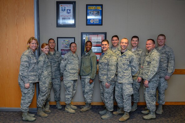 Col. DeAnna Burt, 50th Space Wing commander, and Schriever Airmen gather in front of commemorative plaques acknowledging Schriever Airmen’s performance during Red Flags at Schriever Air Force Base, Colorado, Friday, Feb. 3, 2017. Red Flag is a large-scale exercise held at Nellis Air Force Base, Nevada. Since its inception in 1975, Red Flag has trained more than 440,000 military personnel, flew more than 385,000 sorties and logged more than 660,000 flight hours.  (U.S. Air Force photo/Christopher DeWitt)