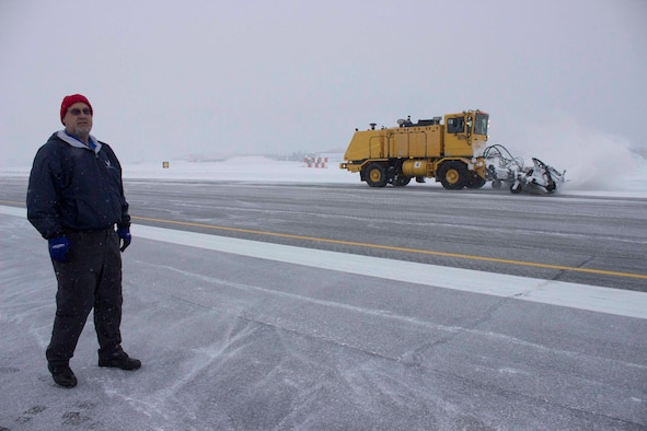 Preston Benedyk, vehicle and snow control manager at the Air Force Civil Engineer Center, evaluates snow removal methods being used at Hill Air Force Base, Utah, during a recent consulting visit. During normal operations, snow brooms clear 50-foot swaths of snow, working from the center of the runway to each edge. (U.S. Air Force Photo/Susan Lawson)