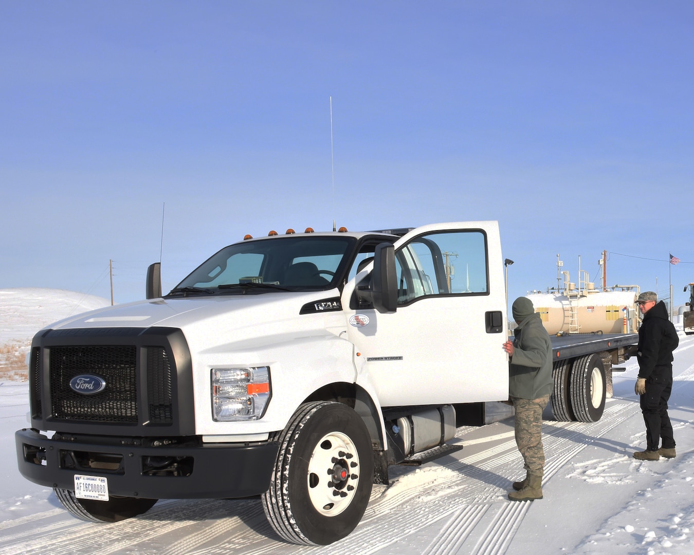 Senior Airmen Leonard Montoya, left, and Ian Lauzon, both 341st Logistics Readiness Squadron vehicle operators, prepare to move a Humvee onto the back of a tow truck at a missile alert facility which will later be transferred to Malmstrom Air Force Base, Mont., for maintenance Feb. 7, 2017.  (U.S. Air Force photo/Jason Heavner)