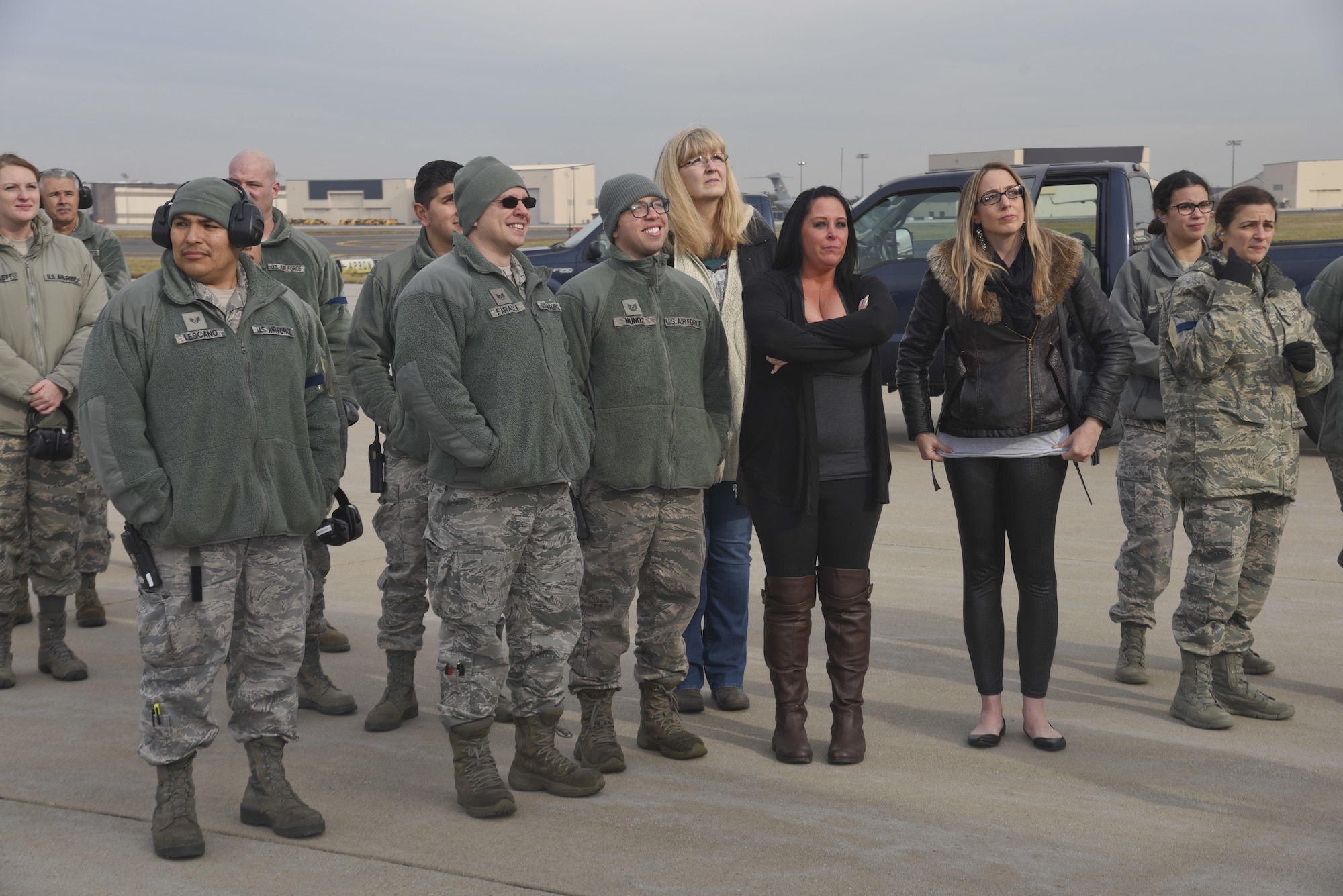Families and friends of deployed Airmen wait for the KC-135R door to open on the flight line at Joint Base McGuire-Dix-Lakehurst, N.J., Dec. 21, 2016. 26 New Jersey Air National Guard Airmen from the 108th Wing returned home after supporting operation Inherent Resolve. (U.S. Air National Guard photo by Staff Sgt. Ross A. Whitley/Released)