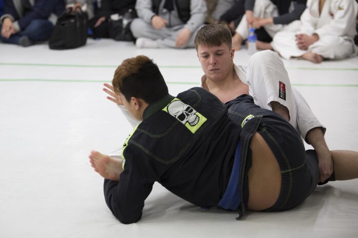 U.S. Marine Corps Lance Cpl. Patrick Hinckley, an aircraft maintenance mechanic with Marine Aviation Logistics Squadron (MALS) 12, fights for a position during the Duamau Tournament, a jiu jitsu competition at the TK Training Center in Hiroshima, Japan, Feb. 5, 2017. Jiu jitsu is an art of weaponless fighting which employs holds and throws to subdue or disable an opponent. Hinckley trains among other Marines at the IronWorks North gym on Marine Corps Air Station Iwakuni. (U.S. Marine Corps photo by Lance Cpl. Joseph Abrego)