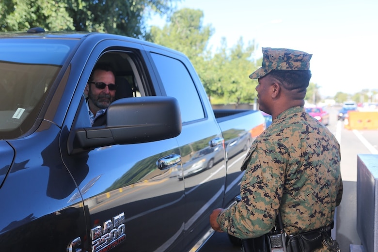 A Marine with the Provost Marshal Office checks identification cards aboard Marine Corps Air Station Miramar, Calif., Feb. 2. The base recently enacted a body camera program as a safety measure for officers working on the air station. (U.S. Marine Corps photo by Cpl. Harley Robinson/Released)