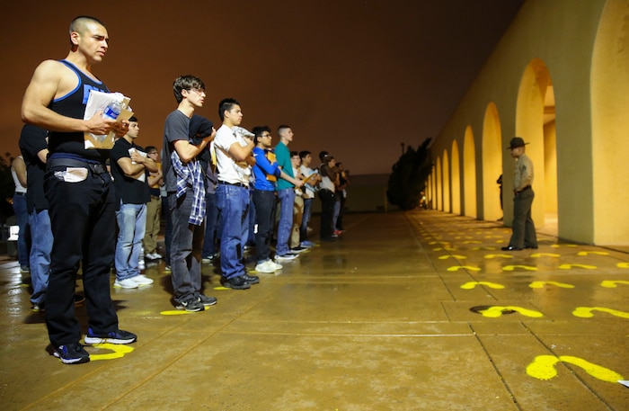 Recruits of Charlie Company, 1st Recruit Training Battalion, stand on the yellow footprints during receiving at Marine Corps Recruit Depot San Diego, Feb. 6. Although recruits are confused and disoriented during this portion of training, the chaos serves a purpose during the transformation from civilian to Marine. Annually, more than 17,000 males recruited from the Western Recruiting Region are trained at MCRD San Diego. Charlie Company is scheduled to graduate May 5.