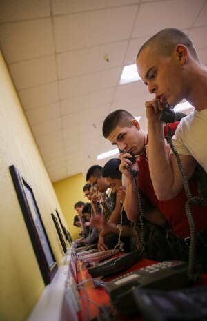 Recruits from Charlie Company, 1st Recruit Training Battalion, make their phone calls home, reading only what is printed on the script in front of them, during receiving at Marine Corps Recruit Depot San Diego, Feb. 6. Recruits will not be able to make another phone call until the end of recruit training. Annually, more than 17,000 males recruited from the Western Recruiting Region are trained at MCRD San Diego. Charlie Company is scheduled to graduate May 5.