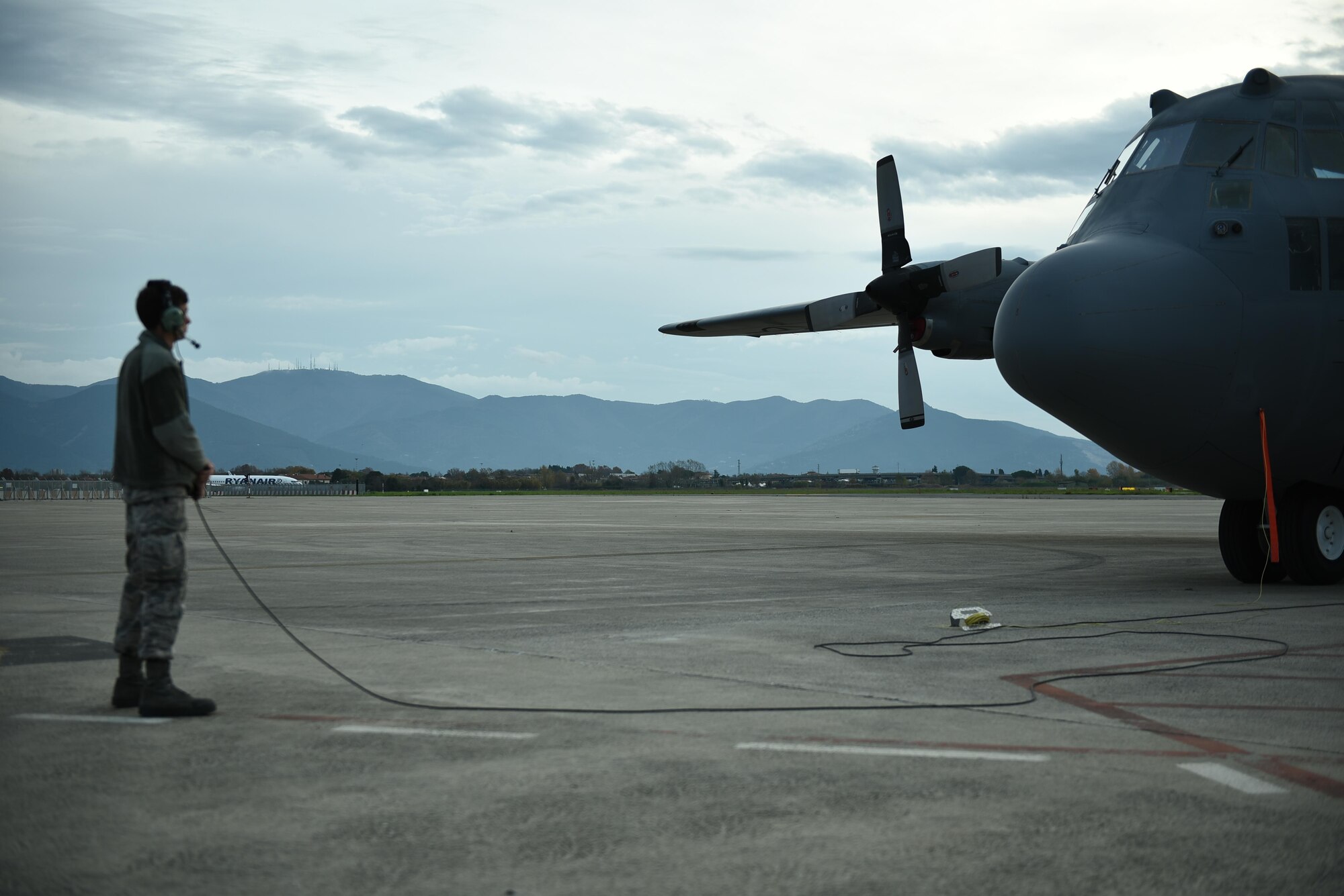 Senior Airman Drew Roberts prepares to marshall a 165th Airlift Wing C-130H3 Hercules during Operation Mangusta in Pisa, Italy. (U.S. Air National Guard photo by Senior Airman Brandon Patterson)
