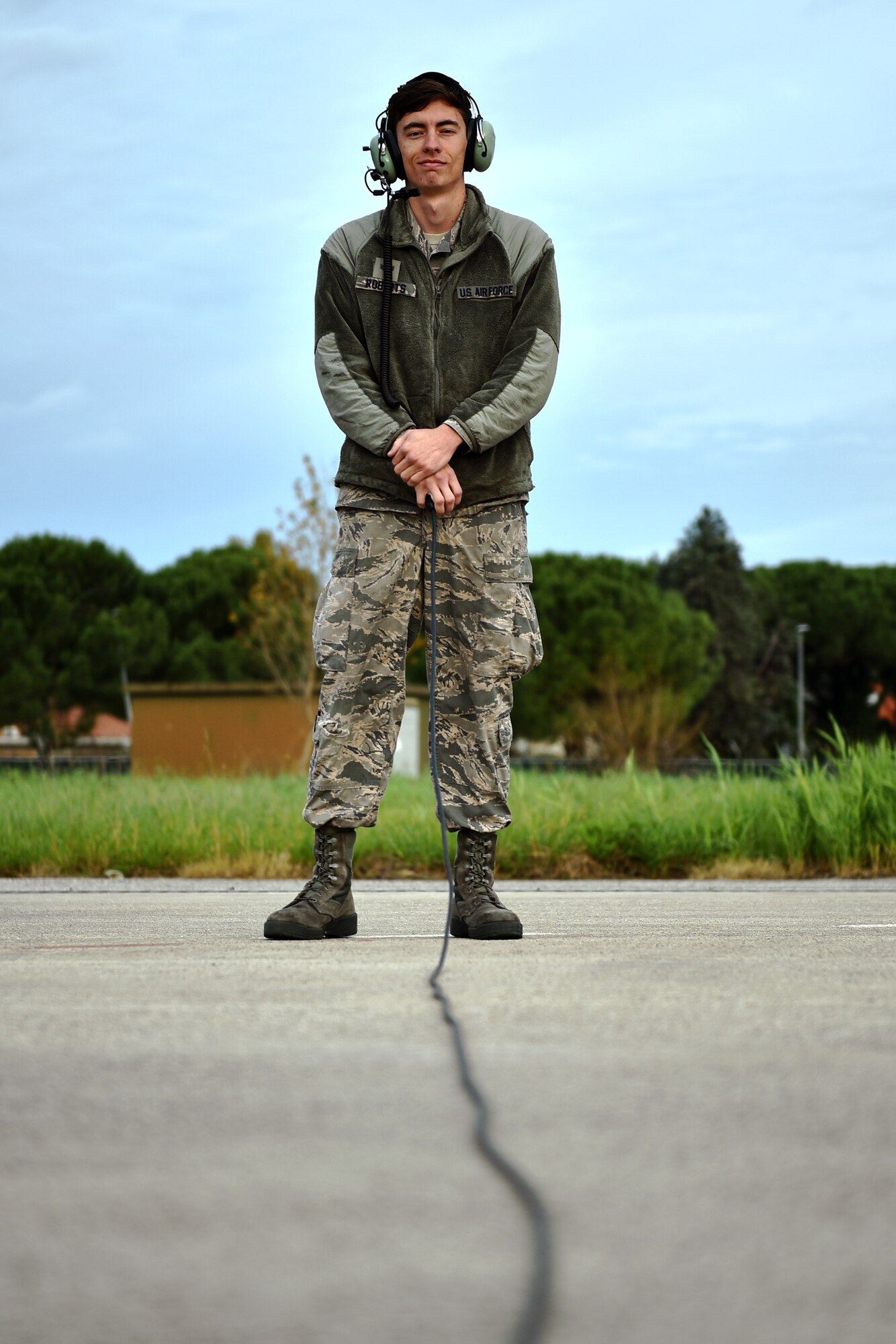 Senior Airman Drew Roberts prepares to marshall a 165th Airlift Wing C-130H3 Hercules during Operation Mangusta in Pisa, Italy. (U.S. Air National Guard photo by Senior Airman Brandon Patterson)
