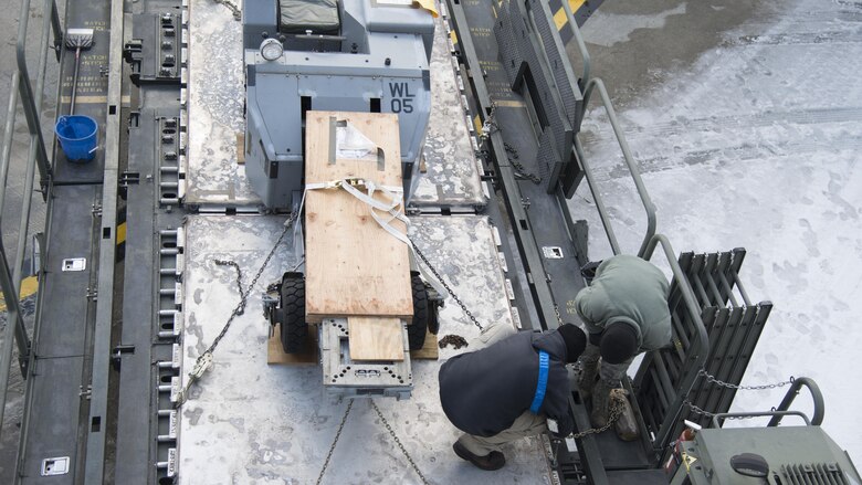 Load crew members guide a pallet onto a 60K-loader at Misawa Air Base, Japan, Feb. 4, 2017. Roughly 170,000 pounds of cargo made its way to Andersen Air Force Base, Guam, in preparation for exercise COPE NORTH 17. The annual exercise that serves as a keystone event promoting stability and security throughout the Indo-Asia-Pacific region. (U.S. Air Force photo by Senior Airman Brittany A. Chase)