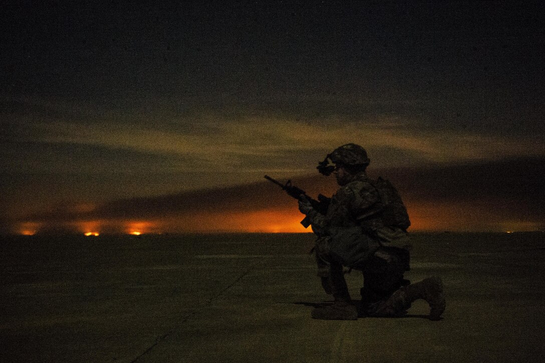 Air Force Senior Airman Henry Nokes secures a section of airfield outside a C-130H Hercules in Qayyarah, Iraq, Feb. 4, 2017. Air Force photo by Senior Airman Jordan Castelan