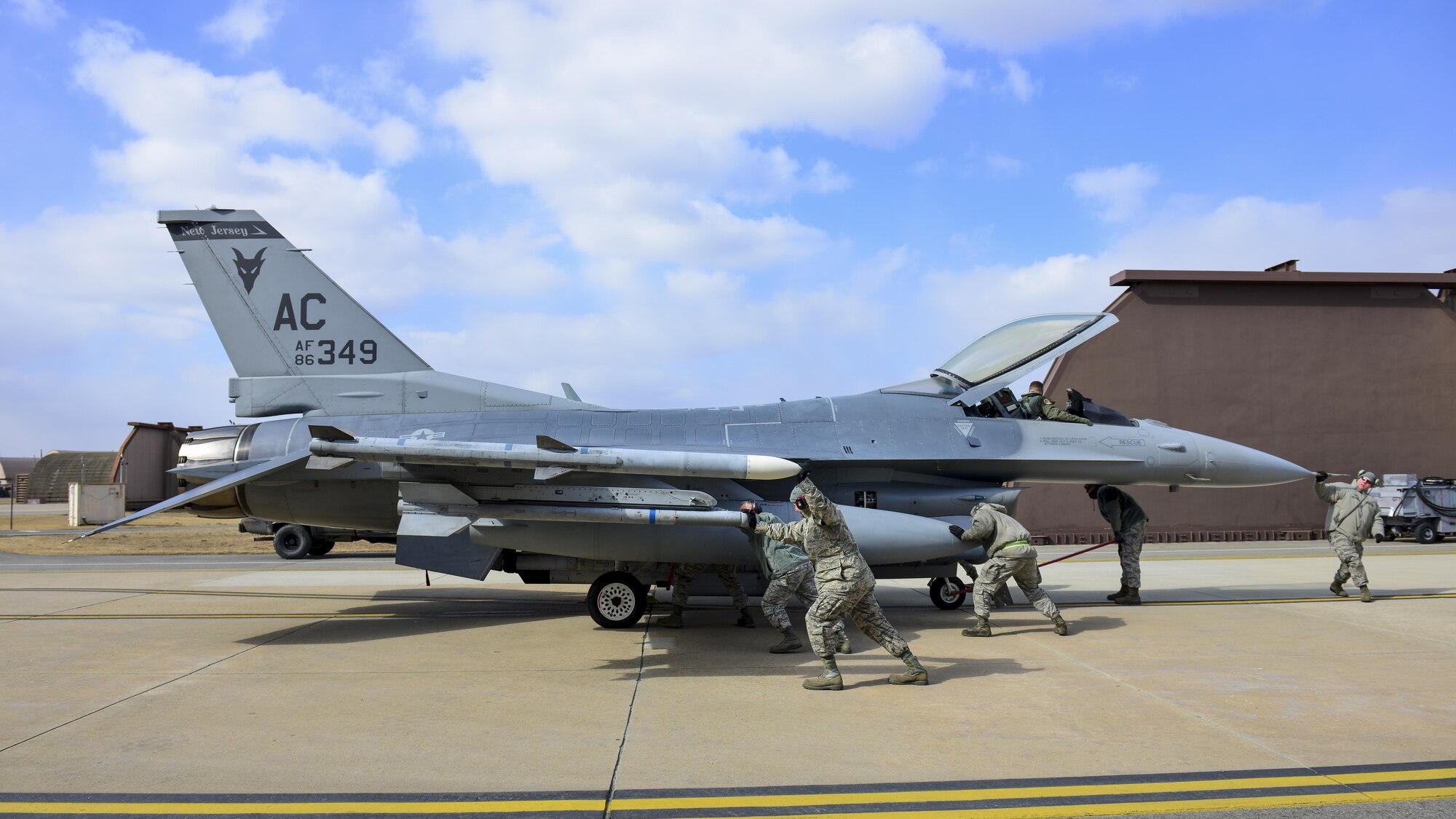 Airmen assigned to the 177th Aircraft Maintenance Squadron from the New Jersey Air National Guard guide an F-16 Fighting Falcon assigned to the 119th Fighter Squadron at Osan Air Base, Republic of Korea, Feb. 9, 2017. The New Jersey Guardsmen are deployed to Osan at the request of Pacific Air Forces, which utilizes Air National Guard units to help bolster the capabilities of allied forces in Korea. (U.S. Air Force photo by Staff Sgt. Victor J. Caputo)