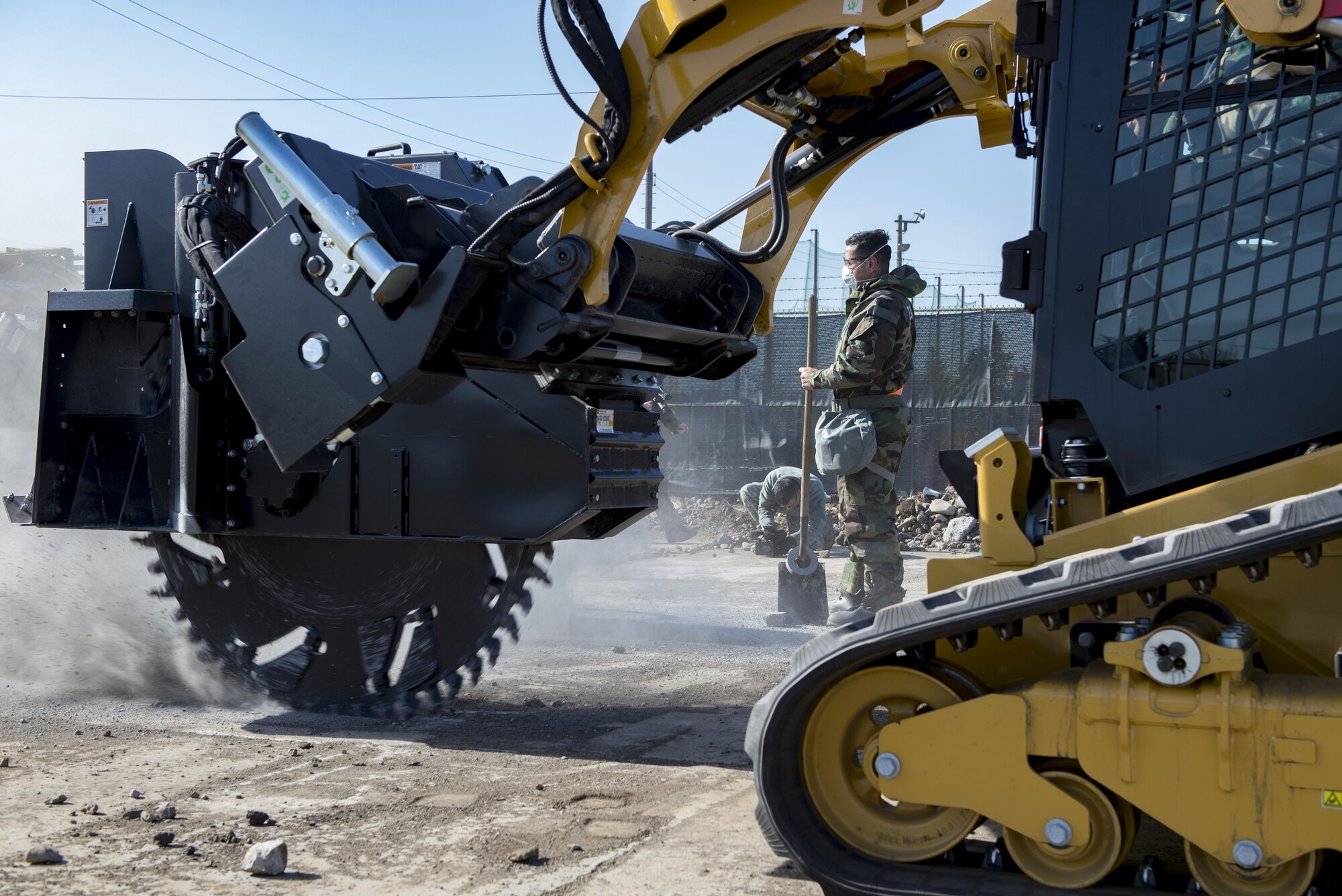 An Airman from the 374th Civil Engineering Squadron oversees concrete cutting during a Rapid Airfield Damage Repair exercise Feb. 8, 2017, at Yokota Air Base, Japan. The 374 CES can repair about 18 damaged runway areas in approximately six hours using the RADR method. (U.S. Air Force photo by Airman 1st Class Donald Hudson)