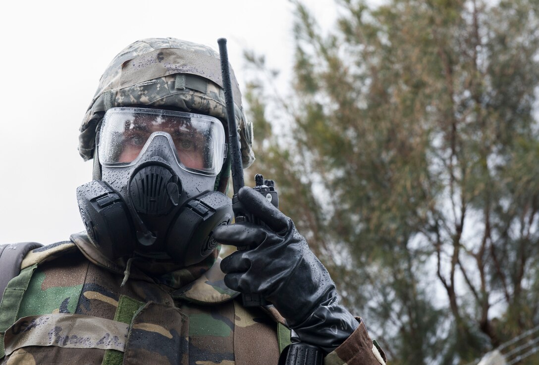 U.S. Air Force Senior Airman Adam Reams, 18th Communications Squadron client systems technician, relays information over a radio during Exercise Green Dragon Feb. 9, 2017, at Kadena Air Base, Japan. When simulated chemical agents or unexploded ordnances are discovered, Airmen on the post-attack reconnaissance team relay the information to initiate the proper response. (U.S. Air Force photo by Senior Airman Lynette M. Rolen/Released)