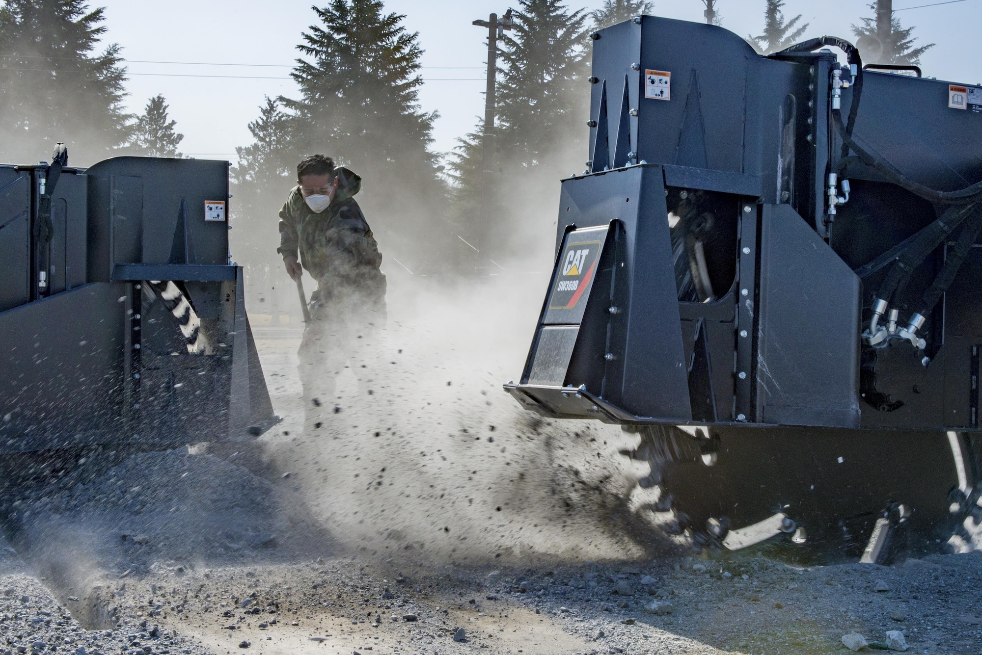 An Airman with the 374th Civil Engineering Squadron clears debris during a Rapid Airfield Damage Repair exercise Feb. 8, 2017, at Yokota Air Base, Japan. RADR is a modern airfield repair process to efficiently fix a runway in the event of an incident. (U.S. Air Force photo by Airman 1st Class Donald Hudson)