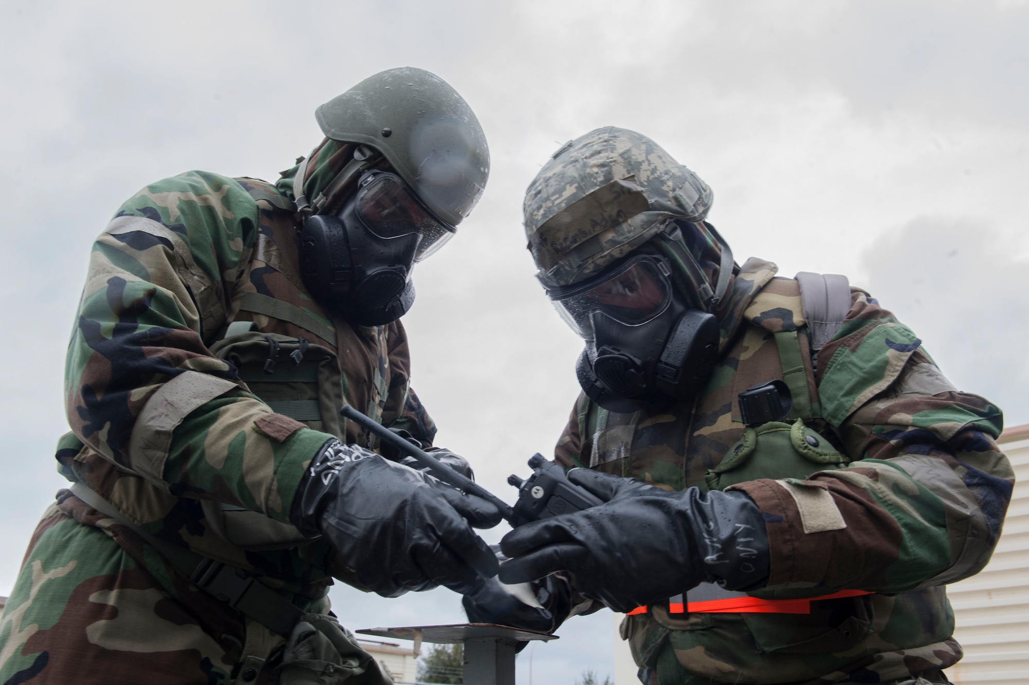 U.S. Air Force Senior Airman Adam Reams and Airman 1st Class Daniel Paolucci, 18th Communications Squadron client systems technicians, conduct a post-attack reconnaissance stand check during Exercise Green Dragon Feb. 9, 2017, at Kadena Air Base, Japan. Exercises such as Green Dragon maintain Kadena’s preparedness to perform in a chemical, biological, radiological and nuclear environment. (U.S. Air Force photo by Senior Airman Lynette M. Rolen/Released)