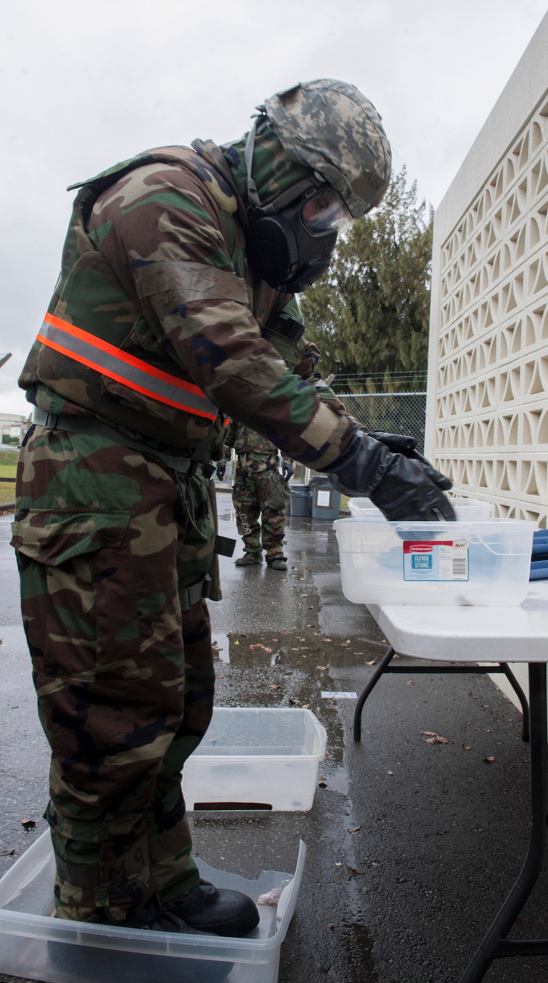 U.S. Air Force Senior Airman Adam Reams, 18th Communications Squadron client systems technician, simulates decontamination procedures during Exercise Green Dragon Feb. 9, 2017, at Kadena Air Base, Japan. Rehearsing chemical attack responses ensures the 18th Wing is ready to conduct operations in the event or threat of an attack. (U.S. Air Force photo by Senior Airman Lynette M. Rolen/Released)