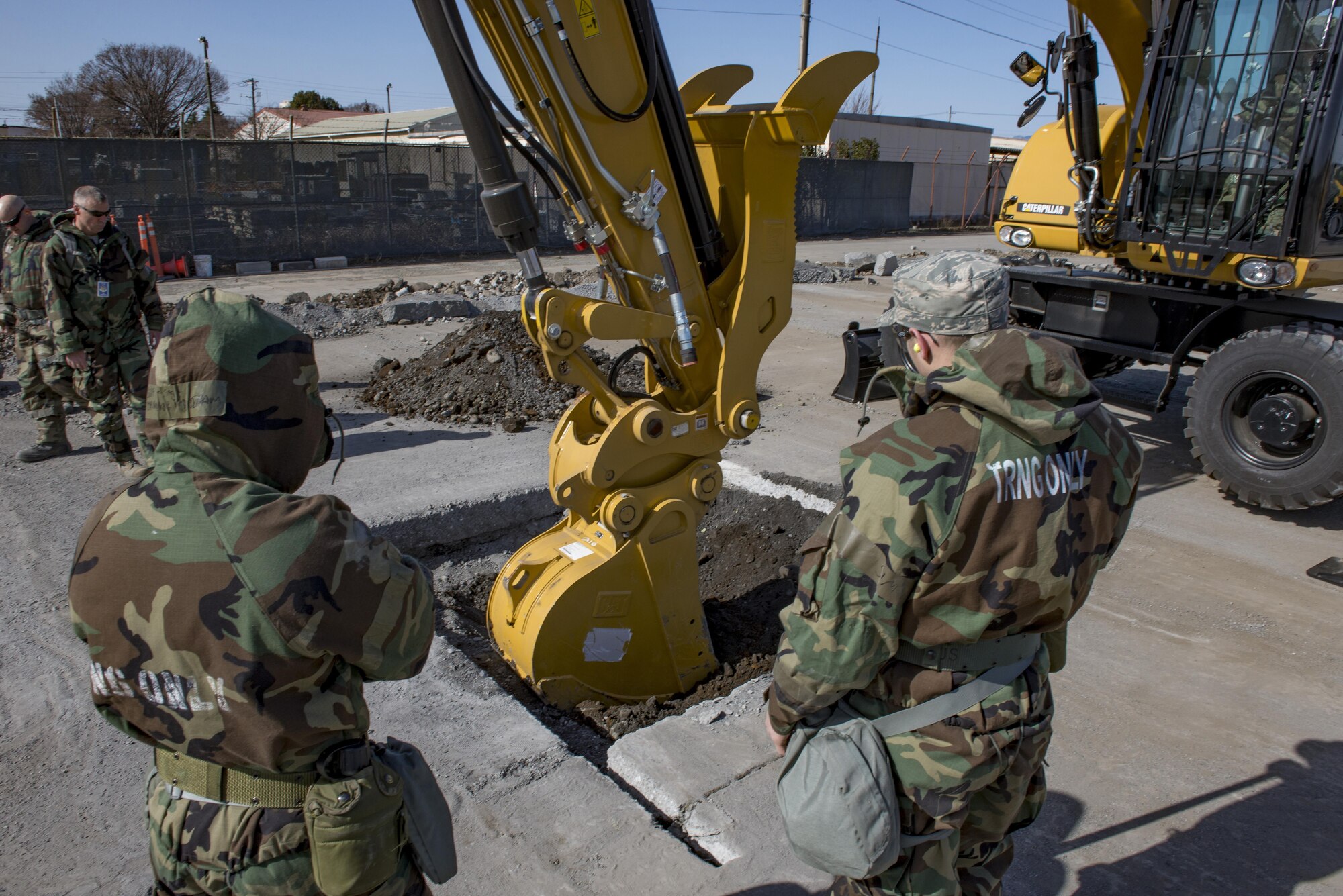 Airmen with the 374th Civil Engineering Squadron oversee dirt removal during a Rapid Airfield Damage Repair exercise Feb. 8, 2017, at Yokota Air Base, Japan. 21 Airmen from the 374 CES participated in the RADR exercise. (U.S. Air Force photo by Airman 1st Class Donald Hudson)