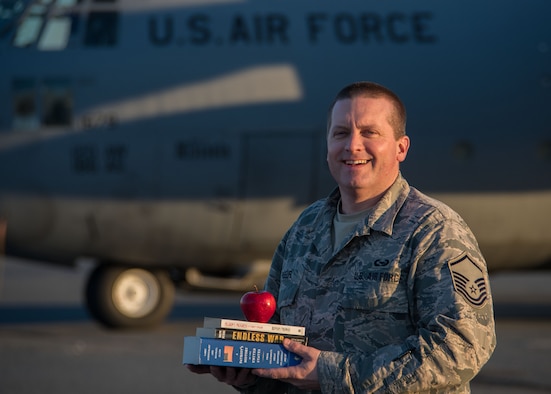 Master Sgt. Jason Paseur, the 386th Air Expeditionary Wing historian, poses for a photo in front of a C-130H Hercules at the flightline here Feb. 7, 2017. Paseur is a reservist deployed from Dobbins Air Reserve Base, Ga. and teaches history as a civilian. (U.S. Air Force photo/Senior Airman Andrew Park)