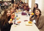 Students at Discovery Middle School in Madison, Alabama hold up their Alabama-grown satsumas during lunch. DLA Troop Support’s Subsistence supply chain provides satsumas to Alabama schools through Department of Defense Fresh program. 