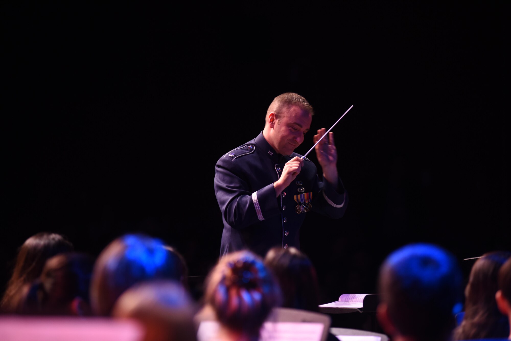 U.S.  Air Forces Central Command Band officer in charge Capt. Justin Lewis conducts an honor band ensemble during the Middle East South Asia Conference at the American School of Doha, Qatar, Feb. 5, 2017. Lewis is the first Air Force band officer to conduct the honor band during the MESAC, an academic and athletic conference consisting of six schools in the Middle East and India. (U.S. Air Force photo by Senior Airman Cynthia A. Innocenti)