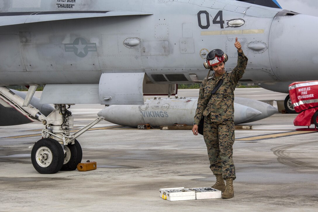 A Marine Corps crew chief gives the thumbs up after inspecting an F/A-18D Hornet aircraft during exercise Cope North at Andersen Air Force Base, Guam, Feb. 3, 2017. Marine Corps photo by Cpl. Nathan Wicks