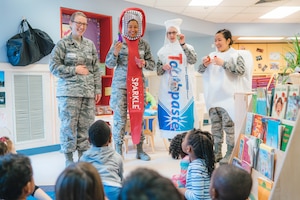 Members of the 779th Dental Squadron show examples of healthy foods to children at the Child Development Center at Joint Base Andrews, Md., Feb. 3, 2017. As part of National Children's Dental Health Month, 779th DS Airmen spoke with children about brushing, flossing and eating healthy snacks. (U.S. Air Force photo by Senior Airman Delano Scott)