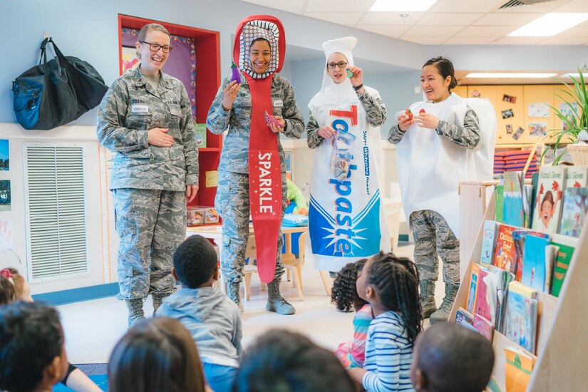 Members of the 779th Dental Squadron show examples of healthy foods to children at the Child Development Center at Joint Base Andrews, Md., Feb. 3, 2017. As part of National Children's Dental Health Month, 779th DS Airmen spoke with children about brushing, flossing and eating healthy snacks. (U.S. Air Force photo by Senior Airman Delano Scott)