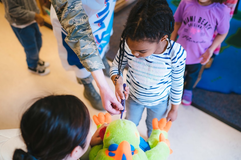 Members of the 779th Dental Squadron show a child how to brush teeth at the Child Development Center at Joint Base Andrews, Md., Feb. 3, 2017. Airmen from the 779th Dental Squadron, in support of Children’s Dental Health Month, visited the base’s CDC to speak with children about healthy eating, proper brushing, flossing and the importance of visiting a dentist regularly. (U.S. Air Force photo by Senior Airman Delano Scott)