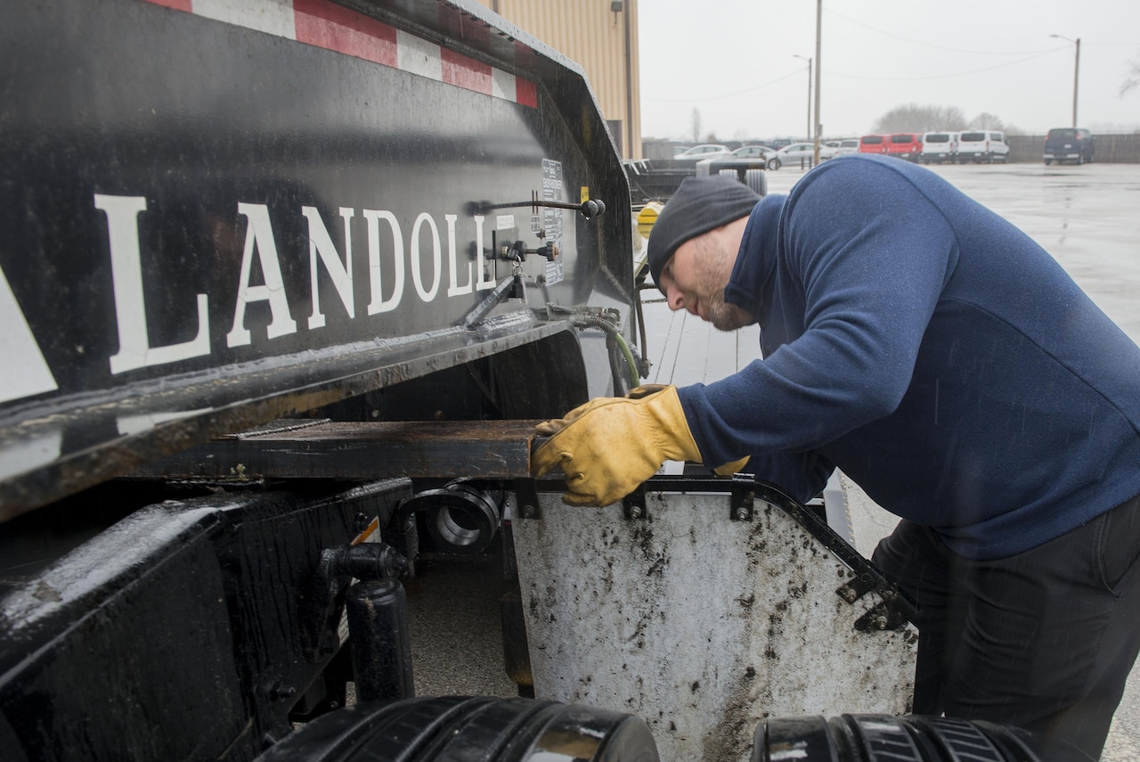 Teddy Manning, 375th Logistics Readiness Squadron chief of personal property, positions the Meyer’s Bar onto the hitch of the lowboy at Scott Air Force Base, Ill., Jan. 19, 2017. Manning assisted in the bar’s creation. Air Force photo by Senior Airman Joshua Eikren