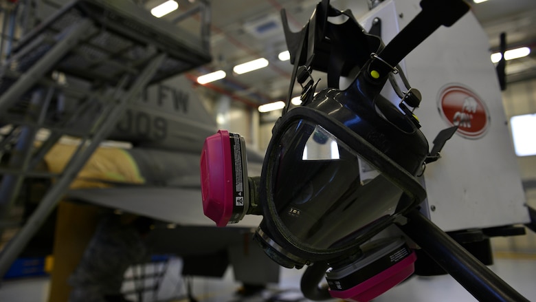 A respirator mask hangs on an air compressor and vacuum system at Aviano Air Base, Italy, Jan. 23, 2017. The 31st Maintenance Squadron Corrosions Airmen must wear these masks to prevent inhaling paint particles during the sanding process. (U.S. Air Force photo by Senior Airman Cary Smith)