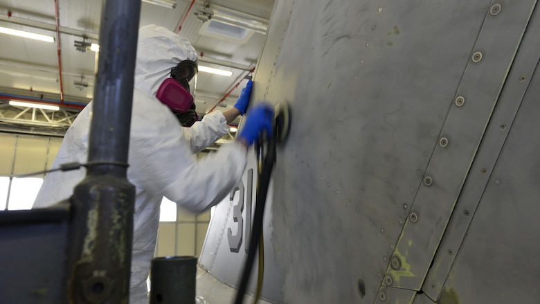 Staff Sgt. Stephen Ramsbacher, 31st Maintenance Squadron Aircraft Structural Maintenance craftsman, sands paint off an F-16 Fighting Falcon tail at Aviano Air Base, Italy, Jan. 23, 2017. The sanding and painting marked the first tail redesign since the 90s. (U.S. Air Force photo by Senior Airman Cary Smith)