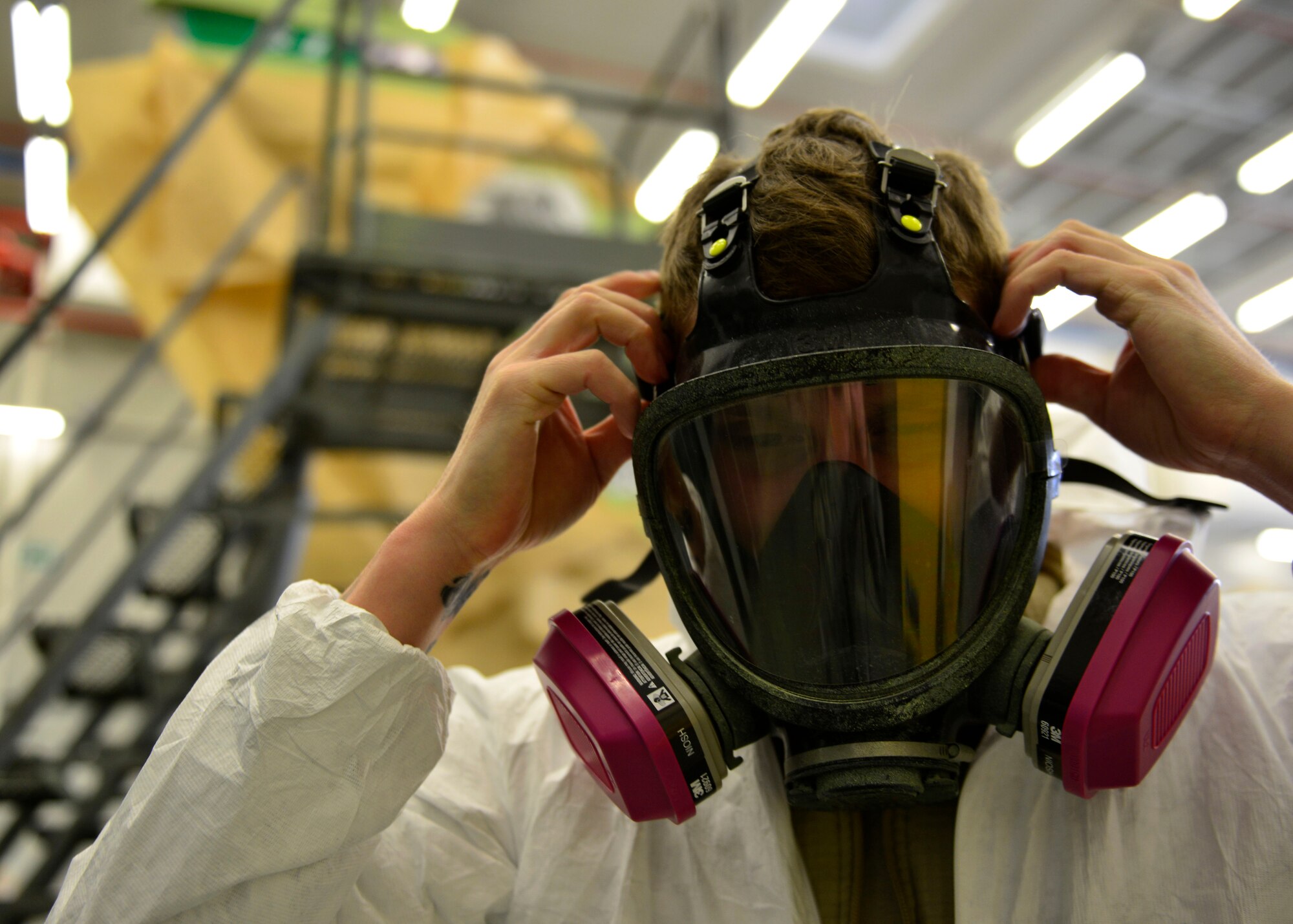 Staff Sgt. Stephen Ramsbacher, 31st Maintenance Squadron Aircraft Structural Maintenance craftsman, secures his respirator mask before painting at Aviano Air Base, Italy, Jan. 27, 2017. Ramsbacher helped prepare and repaint an F-16 Fighting Falcon tail. (U.S. Air Force photo by Senior Airman Cary Smith) 