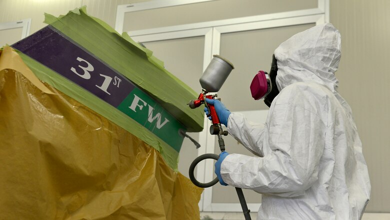 Staff Sgt. Stephen Ramsbacher, 31st Maintenance Squadron Aircraft Structural Maintenance craftsman, sprays clear coat on an F-16 Fighting Falcon tail strip at Aviano Air Base, Italy, Jan. 27, 2017. Ramsbacher helped prepare and repaint an F-16 Fighting Falcon tail. (U.S. Air Force photo by Senior Airman Cary Smith)