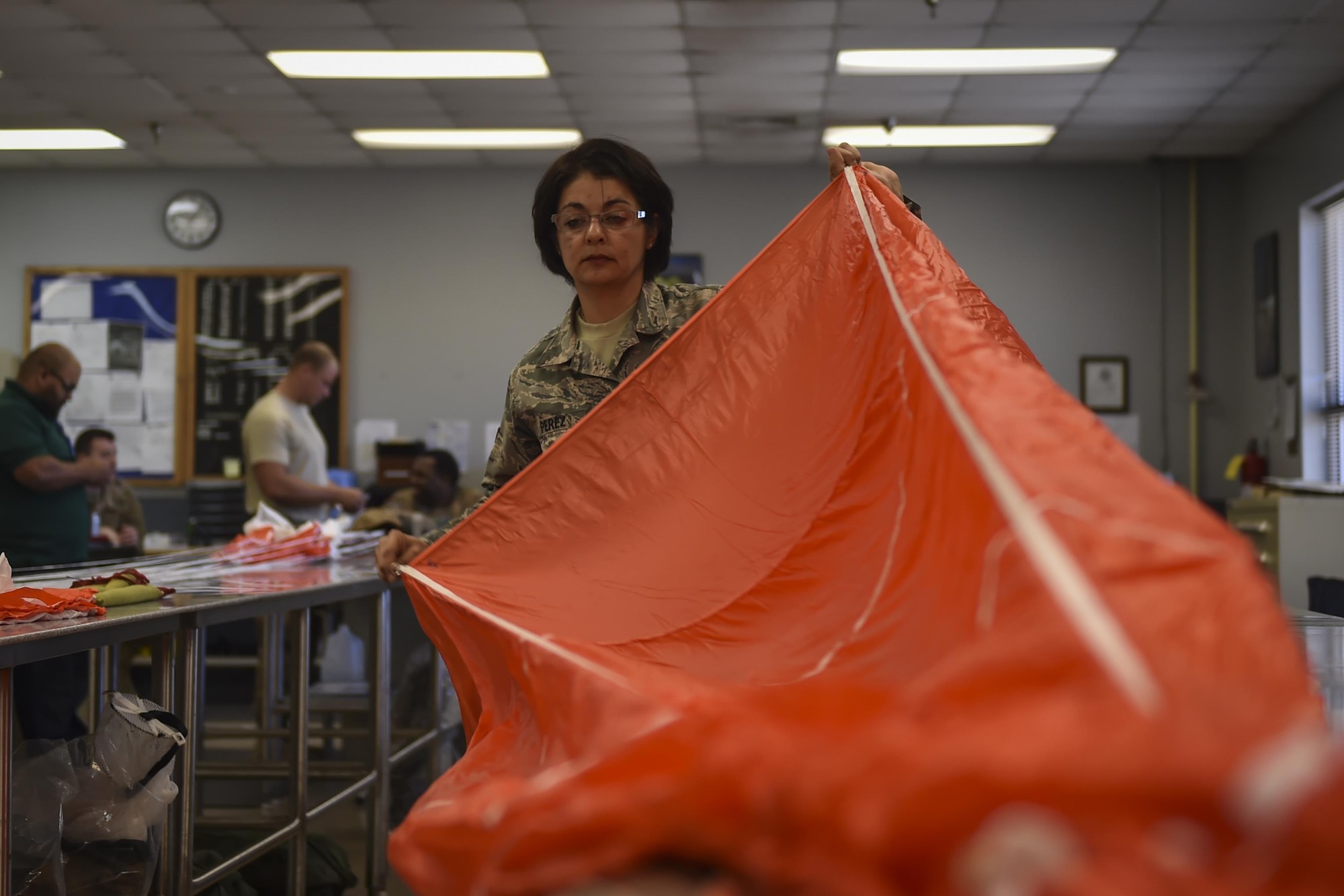 Airman 1st Class Maria Perez, an aircrew flight equipment specialist with the 4th Special Operations Squadron, checks the lines of a low-profile parachute at Hurlburt Field, Fla., Jan. 25, 2017. The LPP is configured for use in the AC-130 gunships and replaced the BA-22 parachute. The LPP weighs approximately 20 pounds, roughly half of the BA-22. (U.S. Air Force photo by Airman 1st Class Joseph Pick)