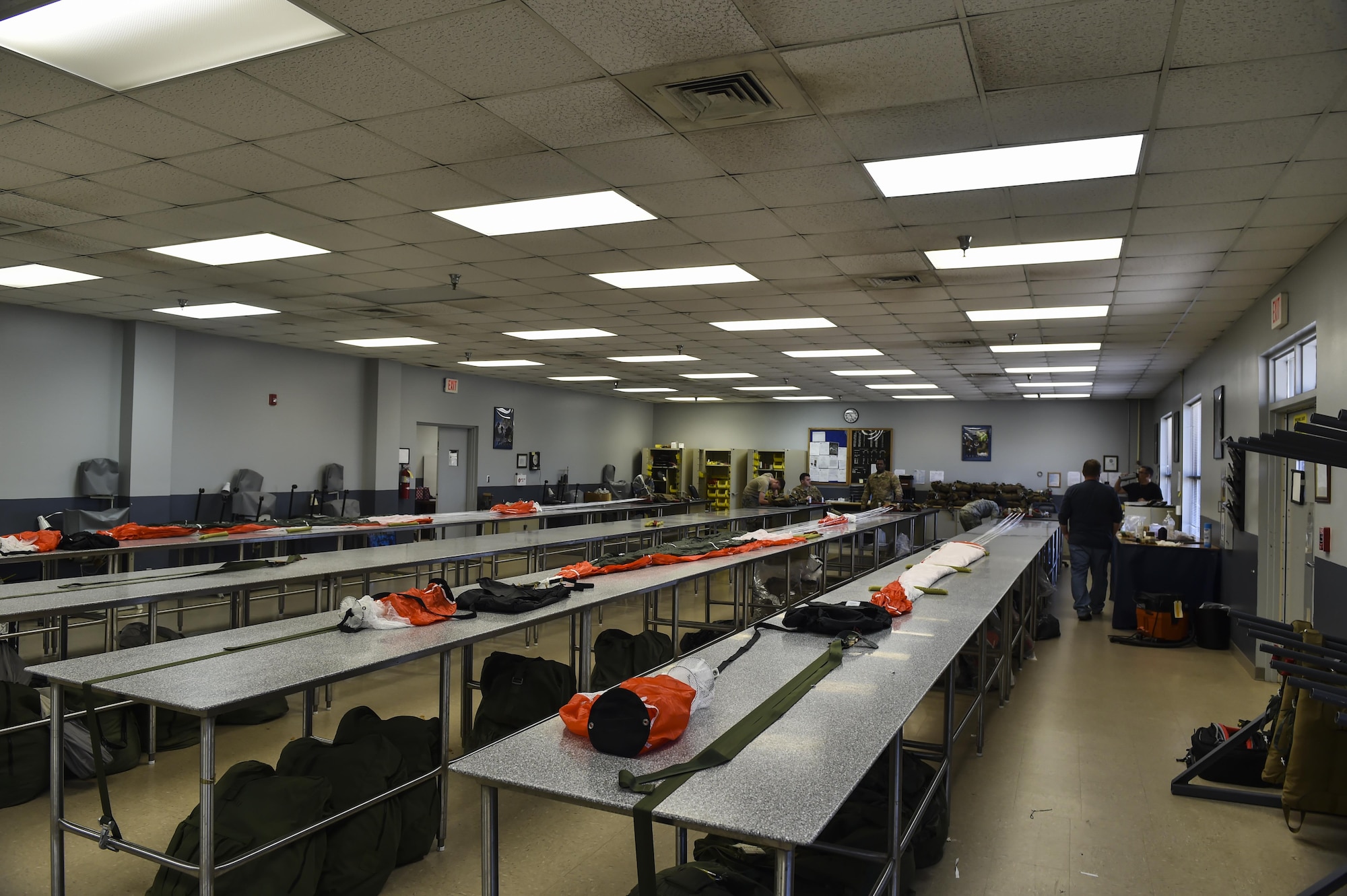 Parachutes line the tables as aircrew flight equipment specialists with the 4th Special Operations Squadron prepare to pack them at Hurlburt Field, Fla., Jan. 25, 2017. Aircrew flight equipment specialists are responsible for maintaining flight equipment such as helmets, oxygen masks, harnesses and all life-saving equipment. (U.S. Air Force photo by Airman 1st Class Joseph Pick)