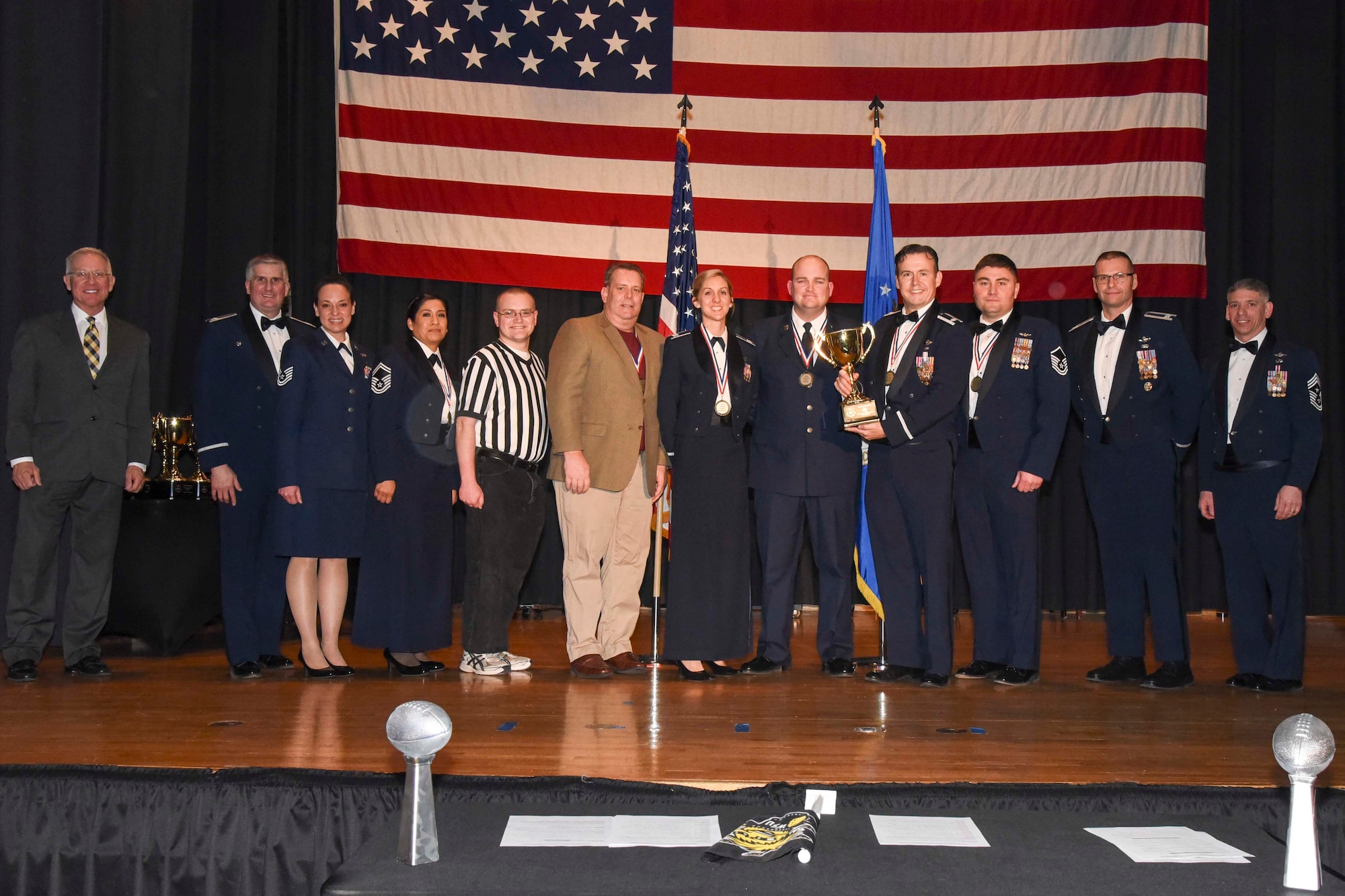 Wing Plans and Programs and Command Post, 22nd Wing Staff Agencies, accepts the 2016 Team of the Year award, Feb. 3, 2017, at McConnell Air Force Base, Kan. The annual awards ceremony recognized military and civilian members who excel in their areas of responsibilities, leadership qualities, community involvement, self-improvement and innovation from January to December 2016. (U.S. Air Force photo/Senior Airman Christopher Thornbury)