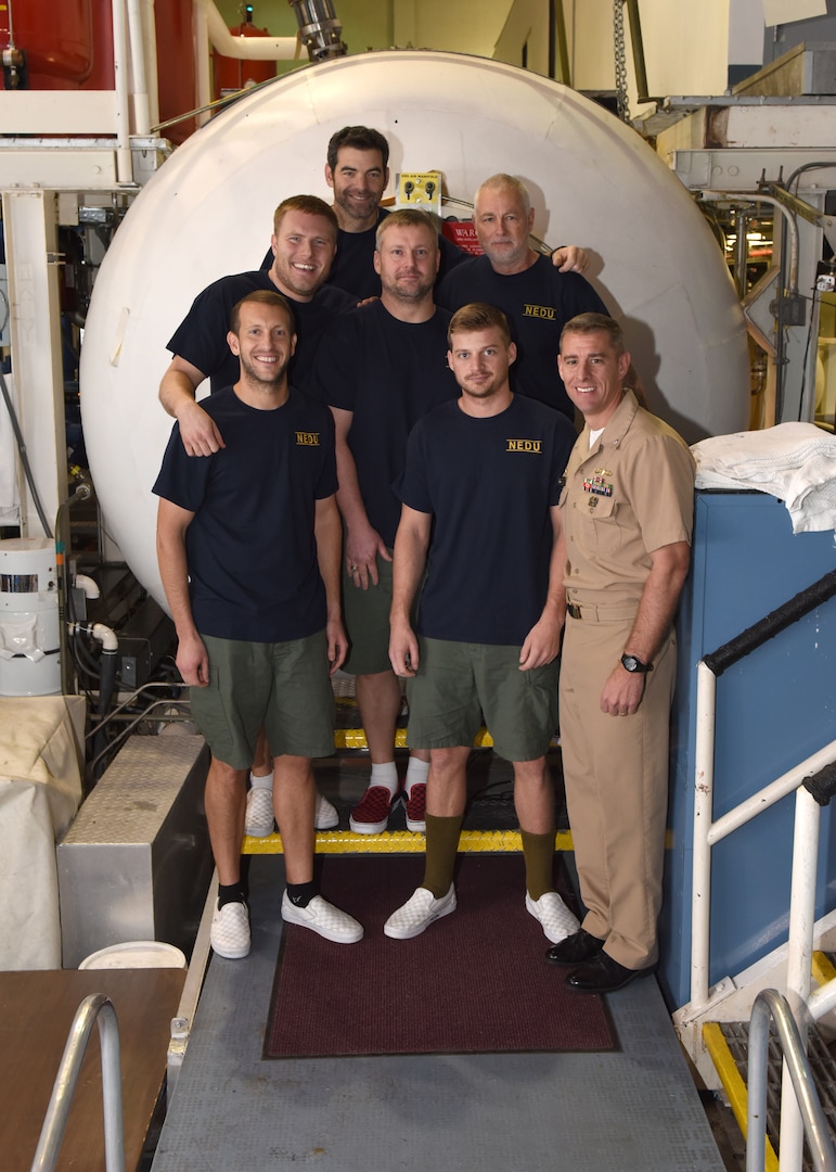 NAVAL SUPPORT ACTIVITY PANAMA CITY Fla. (February 2, 2017) - Sailors at the Navy Experimental Diving Unit (NEDU) stand next to Cmdr. Jay Young, commanding officer of NEDU (right), after emerging from the Ocean Simulation Facility (OSF).  The Sailors coming out of the OSF had just finished the first 500 ft. saturation dive in over 10 years.