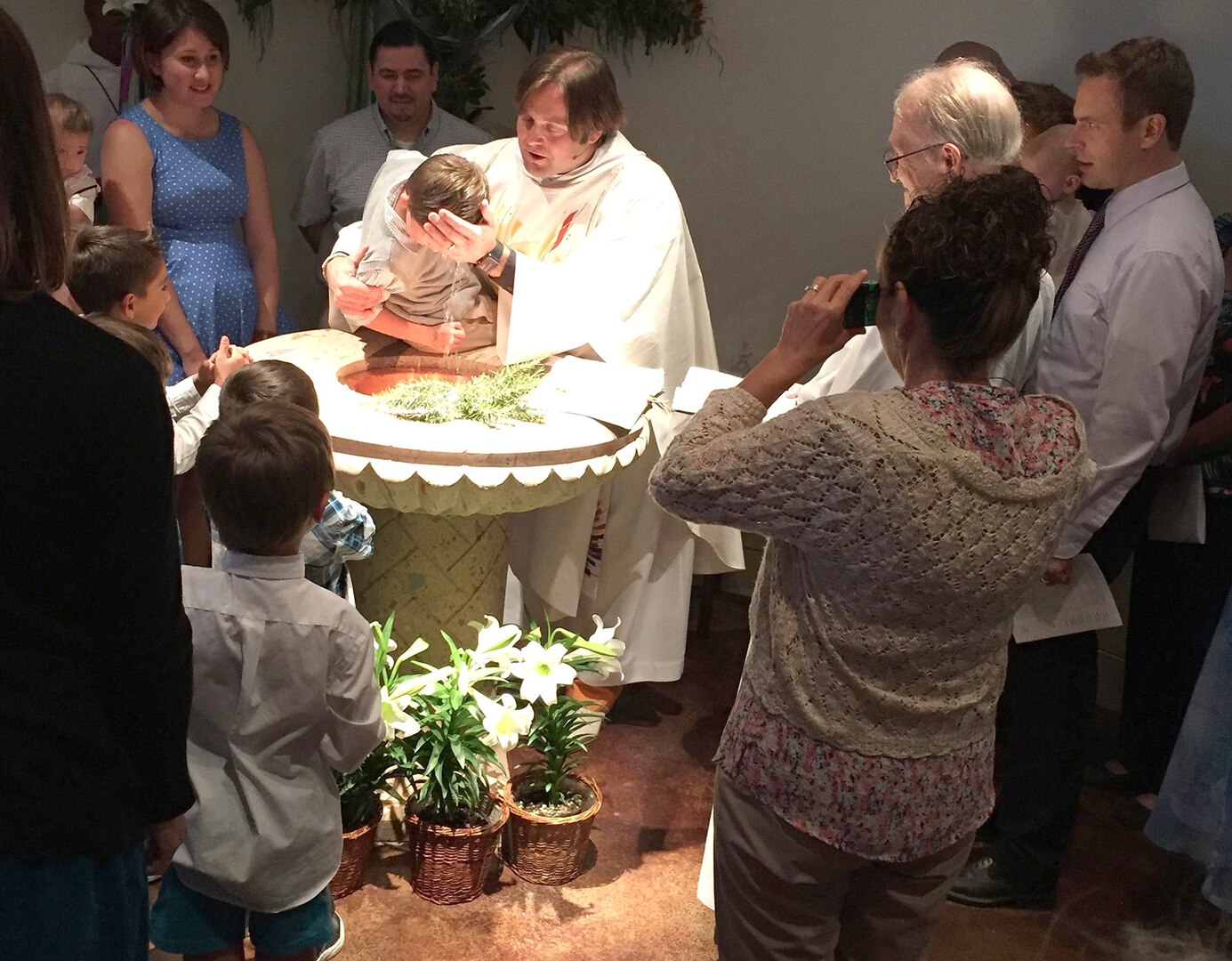 Rev. Ben Nelson III, a Navy Reserve chaplain candidate and rector of St. Mark’s Episcopal Church in San Marcos, Texas, performs a baptism of one of his young parishioners. Nelson is a graduate of Sewanee, The University of the South, where he earned his Masters of Divinity and Doctorate of Ministry.