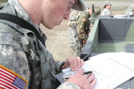 U.S. Army Reserve soldier Spc. Jordan Howes plots his points on his map during the Best Warrio Competition, Fort Hunter Liggett, Calif. on February 7, 2017. Howes plotted his points in preperation for the long land navigation course ahead of him. 