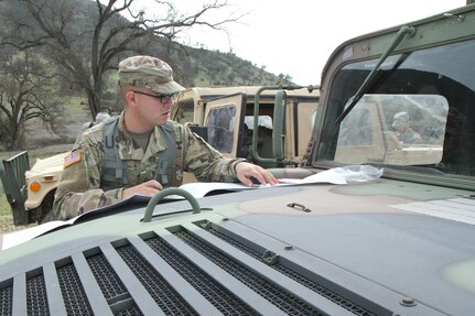 U.S. Army Reserve soldier Pfc. Juan Millan plots his azimuth for land navigatin during the Best Warrior Competition, Fort Hunter Liggett, Calif. on February 7, 2017. Millan plans out an azimuth because it tells you the direction of travel you are going to go to get to the point. 