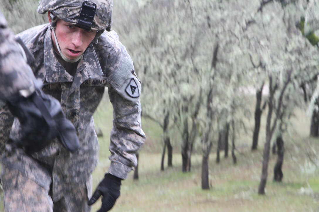 U.S. Army soldier Spc. Jordan Howes listens to instructions given on where the next obstacle is during the obstacle course portion of the Best Warrior Competition Fort Hunter Liggett, Calif. on February 7, 2017. The obstacle course consisted of mostly natural made things like rocks, trees, and hills.