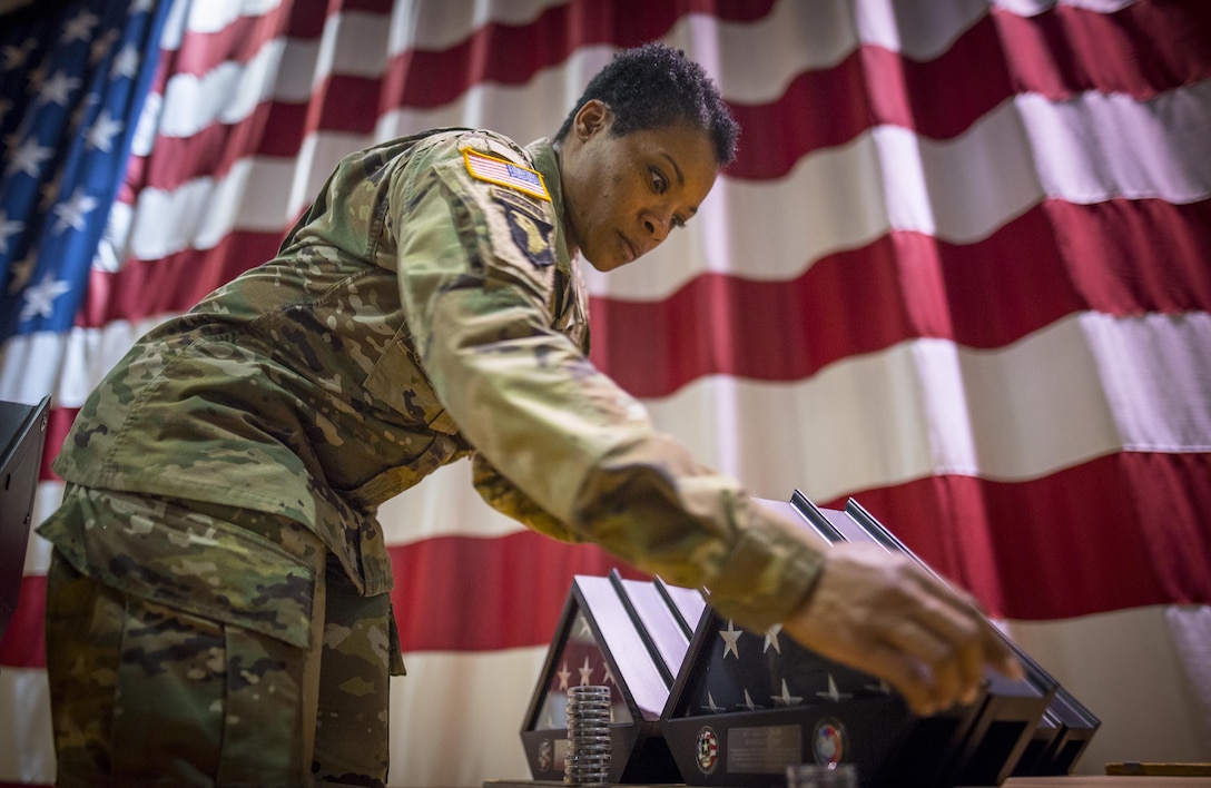 U.S. Army Reserve Capt. Delilah Simmons, the personal readiness branch officer in charge for the 335th Signal Command (Theater), from Demopolis, Ala., sets up awards for the 392nd Expeditionary Signal Battalion’s welcome home ceremony at Fort Hood, Texas, Feb. 6, 2017.