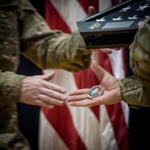 U.S. Army Reserve Maj. Gen. Peter A. Bosse hands a commemorative coin to a Soldier with the 392nd Expeditionary Signal Battalion during a welcome home ceremony at Fort Hood, Texas, Feb. 6, 2017. The battalion had just returned from a nine-month deployment to the Middle East.