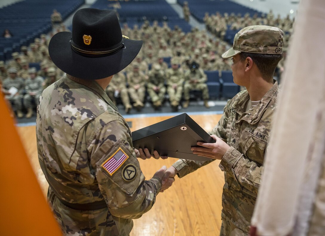 U.S. Army Reserve Maj. Gen. Peter A. Bosse, commander of the 335th Signal Command (Theater), hands a commemorative flag to a member of the 392nd Expeditionary Signal Battalion during a welcome home ceremony at Fort Hood, Texas, Feb. 6, 2017. The battalion had just returned from a nine-month deployment to the Middle East. 