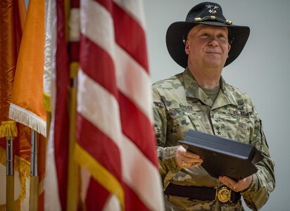 U.S. Army Reserve Maj. Gen. Peter A. Bosse, commander of the 335th Signal Command (Theater), waits to hand a commemorative flag to a member of the 392nd Expeditionary Signal Battalion during a welcome home ceremony at Fort Hood, Texas, Feb. 6, 2017. 