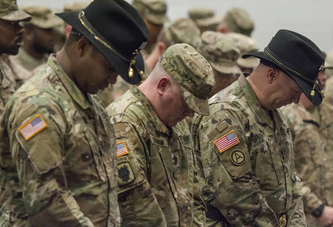 U.S. Army Reserve senior leadership, including 335th Signal Command (Theater) Commander Maj. Gen. Peter A. Bosse (right), bow their heads in a moment of thanks for the 392nd Expeditionary Signal Battalion’s safe return from the Middle East during a welcome home ceremony at Fort Hood, Texas, Feb. 6, 2017. (U.S. Army photo by Staff Sgt. Ken Scar)