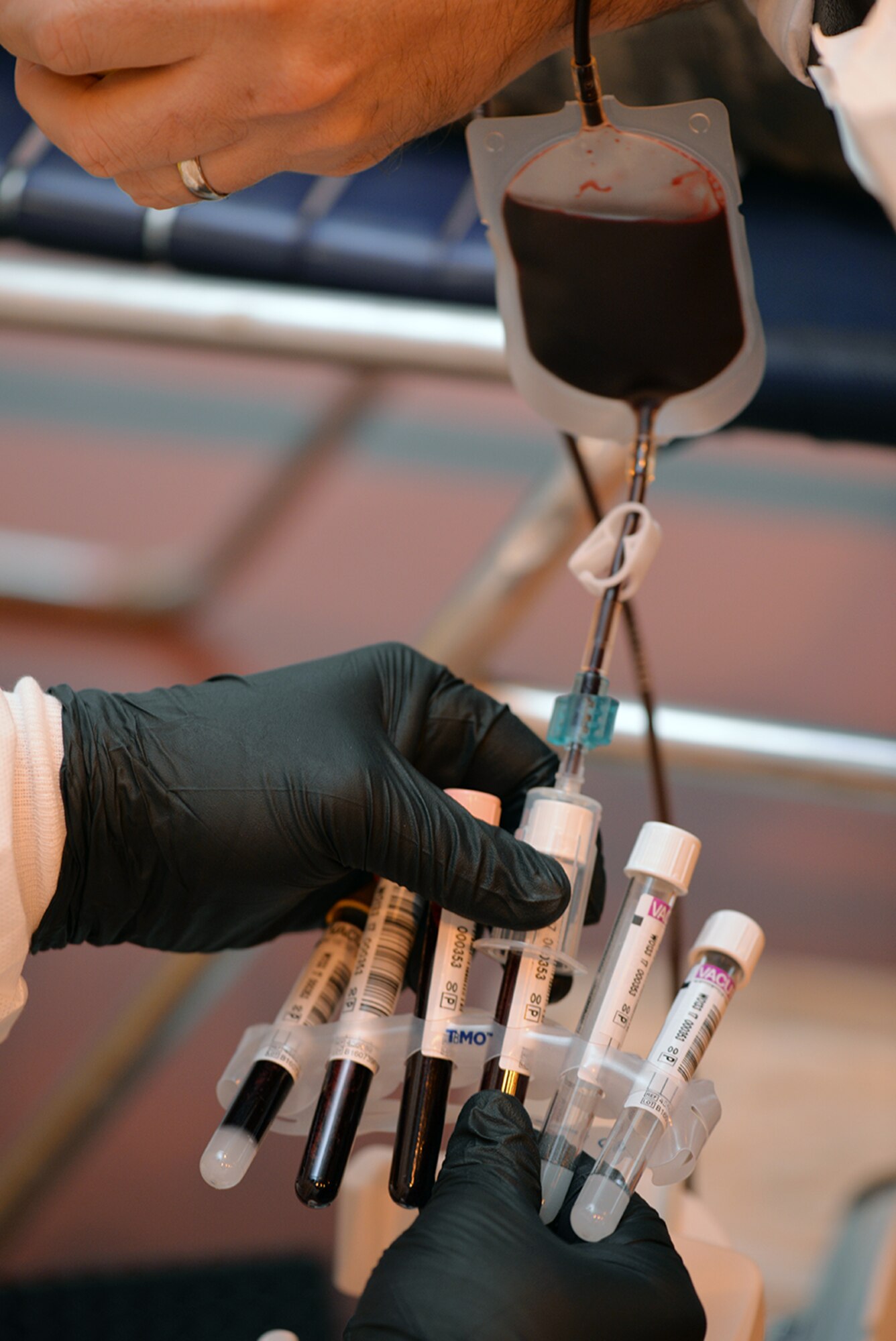 A medical lab technician from Armed Services Blood Program-Europe, Landstuhl Regional Medical Center, Germany, fills test tubes with blood after a donor’s collection bag has been filled at the ASBP blood drive Feb. 7, 2017, on RAF Mildenhall, England. Airmen from RAF Mildenhall and RAF Lakenheath volunteered their time to help at various stations at the blood drive. (U.S. Air Force photo by Karen Abeyasekere)