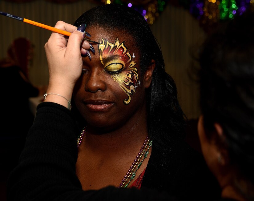 Felita Morgan, Warriors Café dining facility manager, has her face painted during the Mardi Gras event hosted at the Fort Eustis Club at Joint Base Langley-Eustis, Va., Feb, 3, 2017. Mardi Gras is traditionally hosted in New Orleans, La., after becoming a legal holiday in Louisiana in 1875. (U.S. Air Force photo by Staff Sgt. Teresa J. Cleveland)