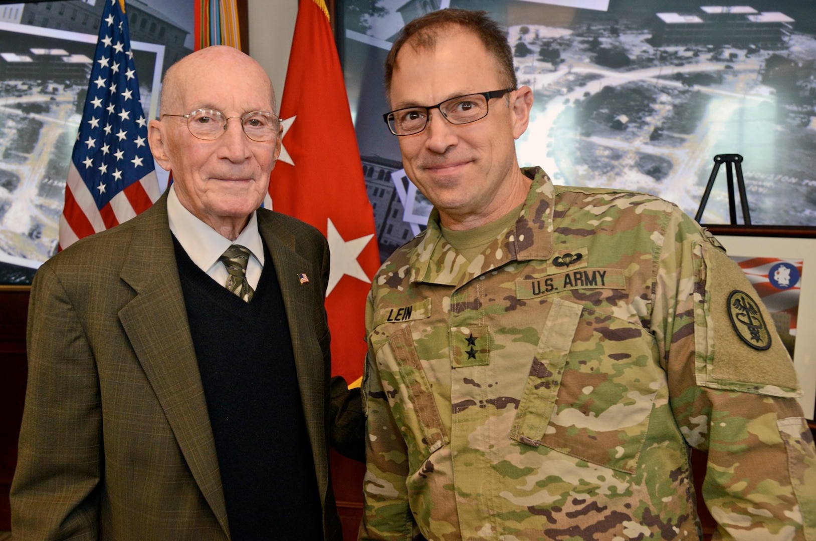 Retired Maj. Gen. (Dr.) Floyd Baker (left), former Brooke Army Medical Center commander, and Maj. Gen. Brian Lein (right), commanding general, U.S. Army Medical Department Center and School, pose for a picture during the ceremony for the 80th anniversary of Building 1000 Feb. 3. The building now houses U.S. Army South and is affectionately known as "Old BAMC."