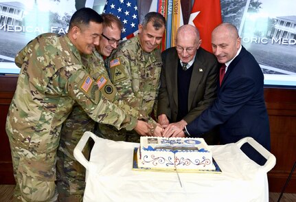 Distinguished guests and leadership from U.S. Army South and the U.S. Army Medical Department Center & School at Joint Base San Antonio-Fort Sam Houston, participate in the traditional cutting of the cake Feb. 3 to celebrate the 80th Anniversary of building 1000. The building now house the headquarters for U.S. Army South and is affectionately known as "Old BAMC."